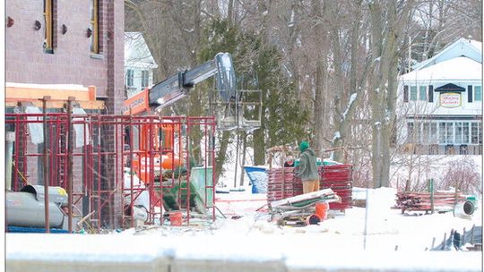 Workers brave the temperatures constructing the new Bluebird building in Leland Wednesday
