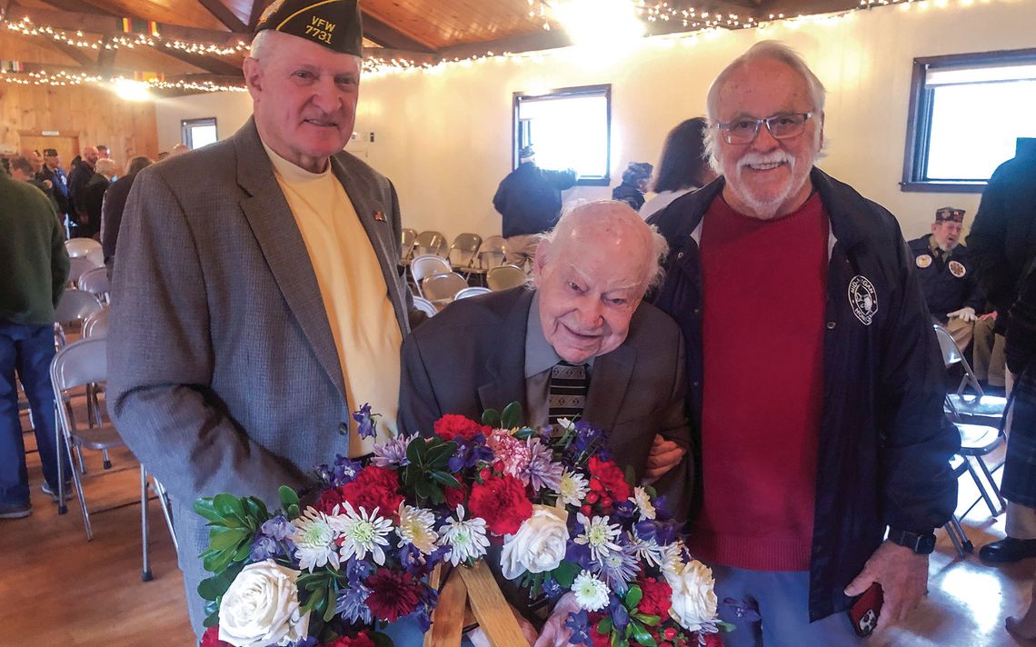 Standing by the remembrance wreath are Leelanau County veterans Gene Kelly, master of ceremonies, D-Day soldier Dick Grout and Vietnam War soldier Steve Stanton. See more coverage on Pg. 6. Courtesy photo