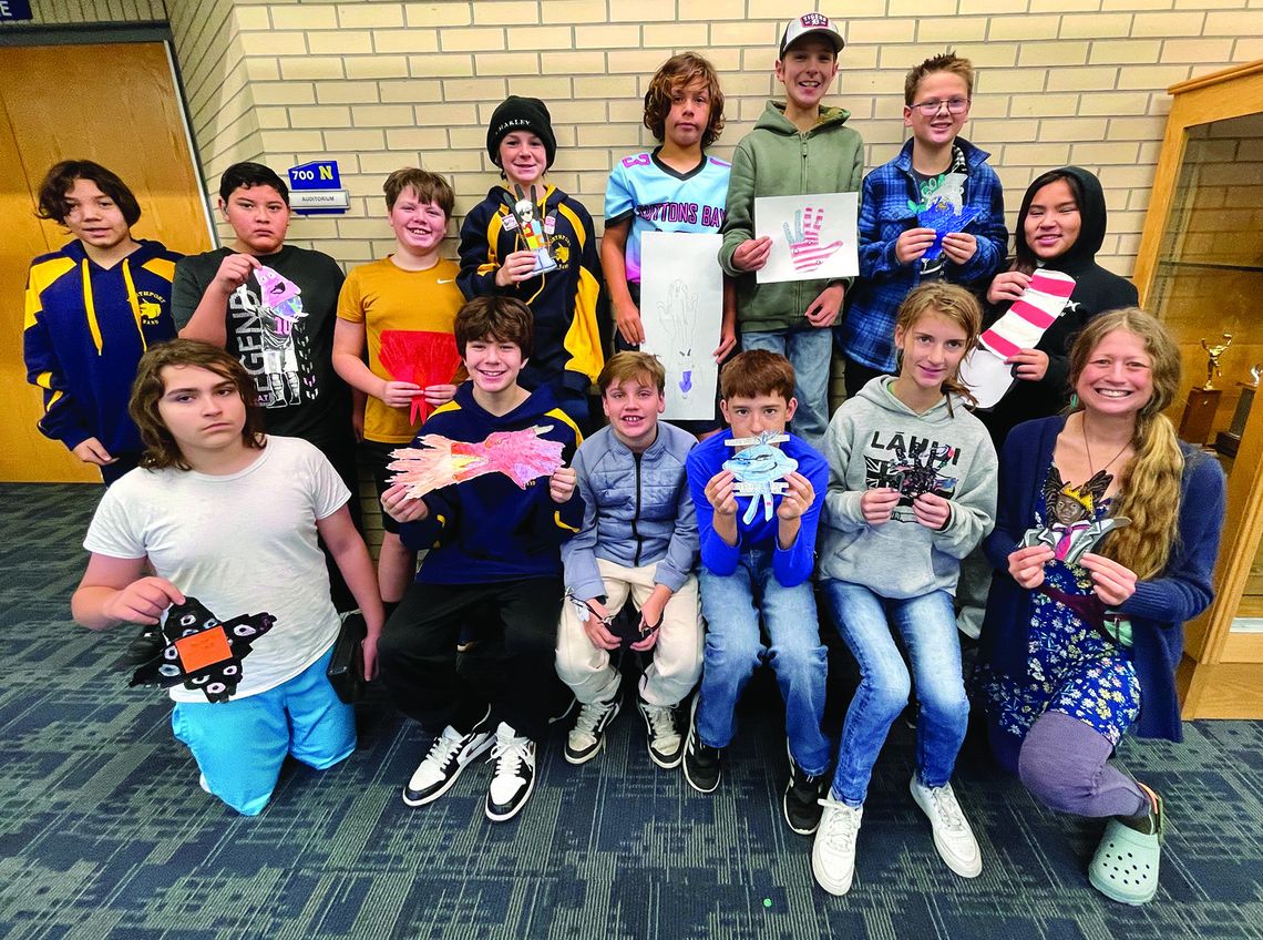 Northport Public School Art Teacher Jen Evans is pictured with students from the sixth grade class and their hand turkey creations. Photo courtesy of Jen Evans