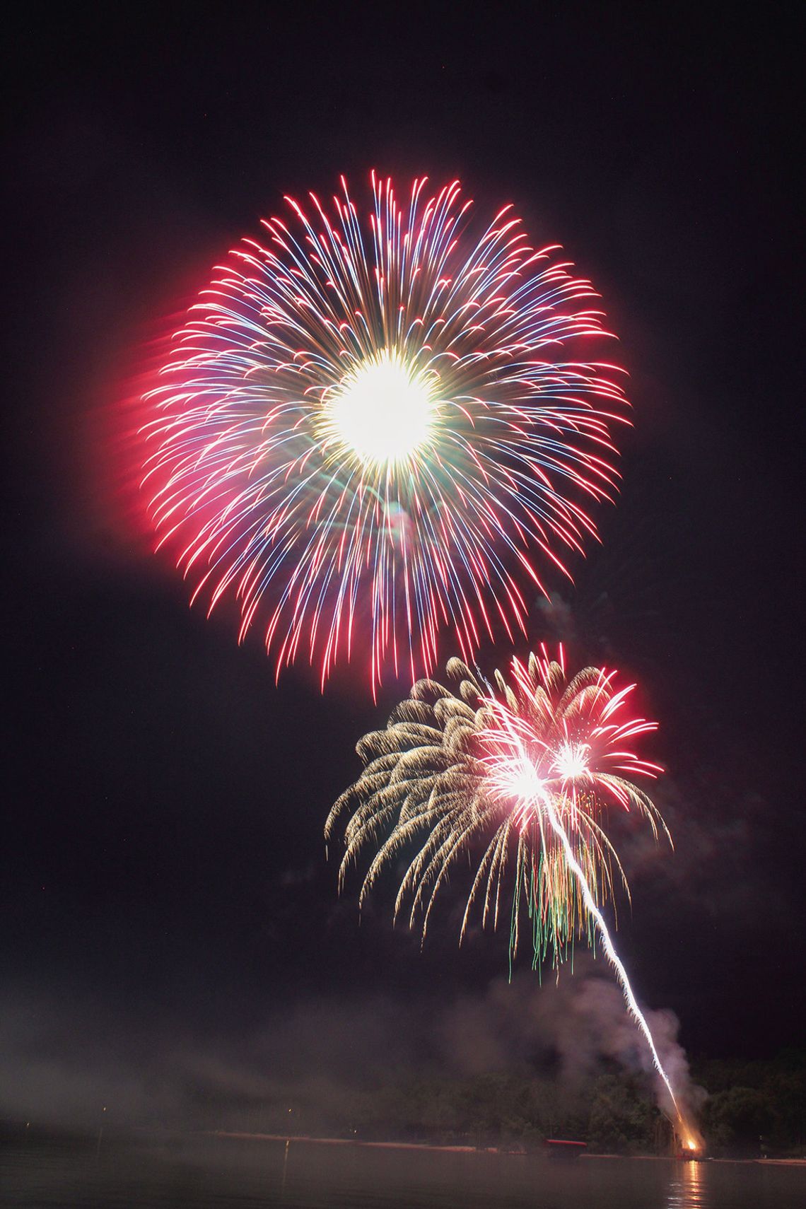 Fireworks blast off from a small raft on Northport Bay for all to see from boats and on land. Enterprise photo by Brian Freiberger