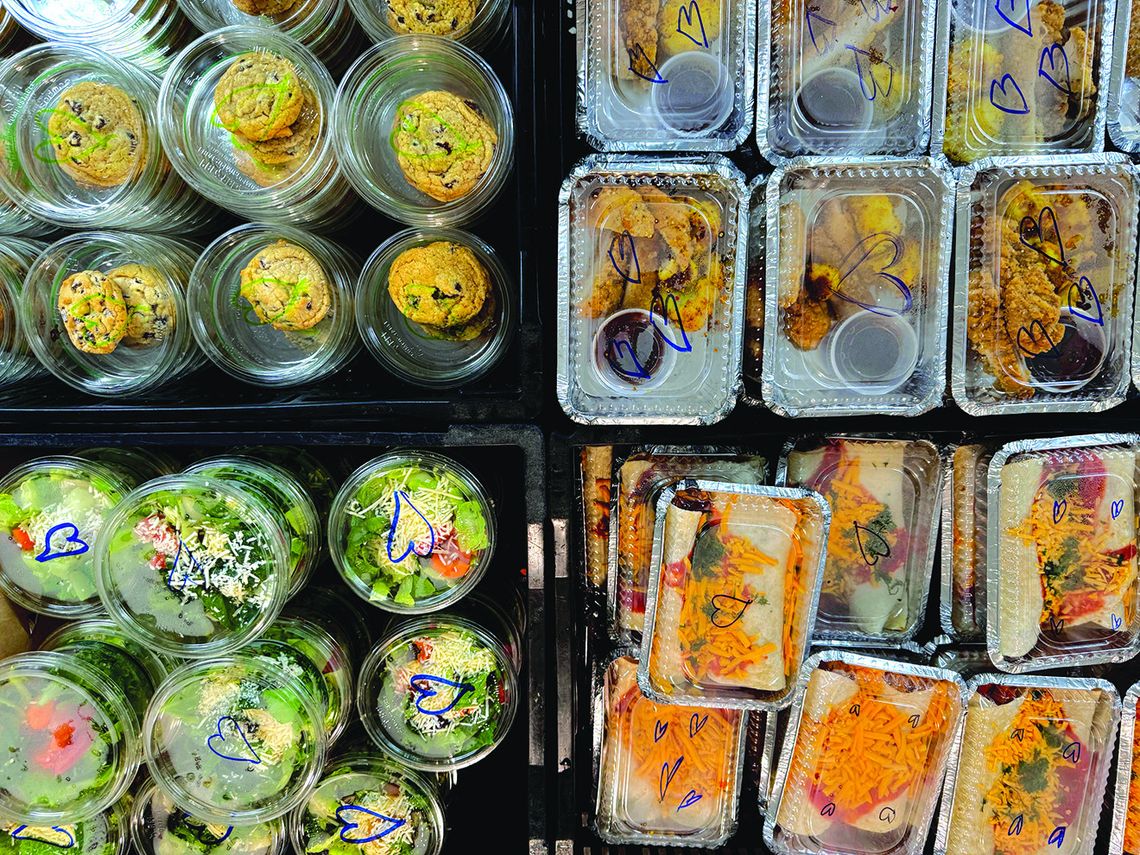 A bird’s eye view of the meals to-go at Peshawbestown’s St. Kateri Tekakwitha Catholic Church last week Thursday. Pictured are the stacks of crates filled with chocolate chip cookies, pumpkin cheesecake, chicken tenders, and sweet potato and black bean enchiladas. Courtesy photo
