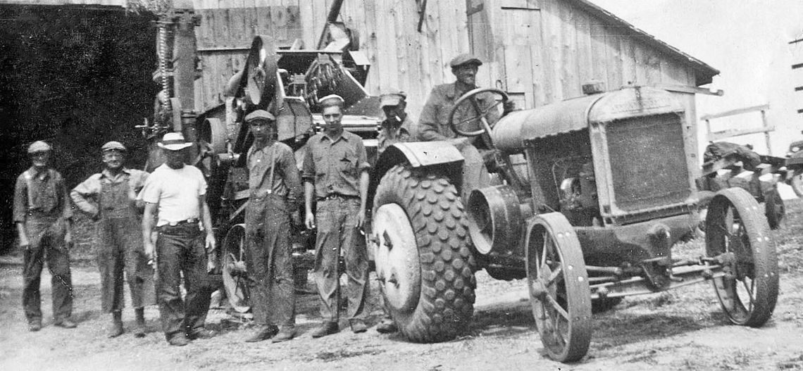 Here’s a thrashing crew at Art &amp; Laura Basch’s farm, using Henry &amp; Ernie Anderson’s thrashing machine. That’s Ernie on the tractor, and his brother Henry three men to the left. Preserve Historic Sleeping Bear Online Archive