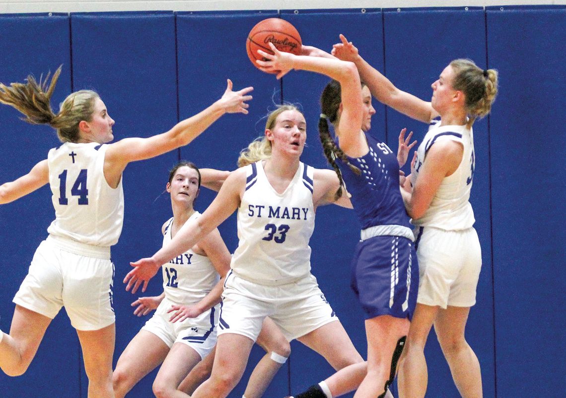 Lake Leelanau St. Mary defenders Delana Kirt (left), Leah Fleis (middle), and Cathryn Mikowski (right) pressure a Gaylord St. Mary player in the first half of Monday night’s game. The Eagles went into halftime up 21-15. Enterprise photo by Brian Freiberger