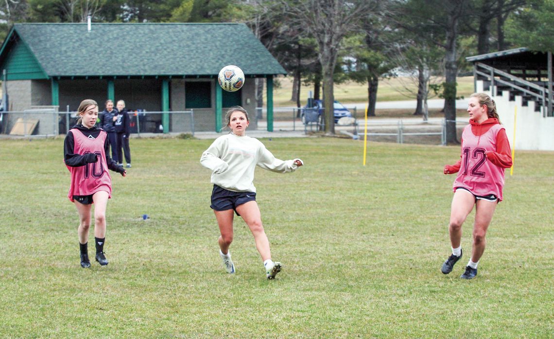 A trio of Leland Comets battle for possession during a drill at spring practice Monday. Enterprise photo by Brian Freiberger