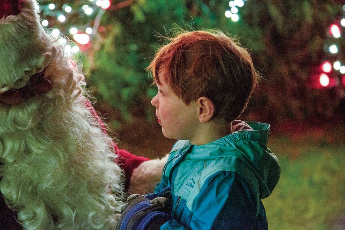 Magnus Goodell, son of Matt and Nora Goodell of Lake Leelanau, was in awe of Santa Claus at the Light Up Leland celebration in 2023 that kicked off the holiday season. Courtesy photo