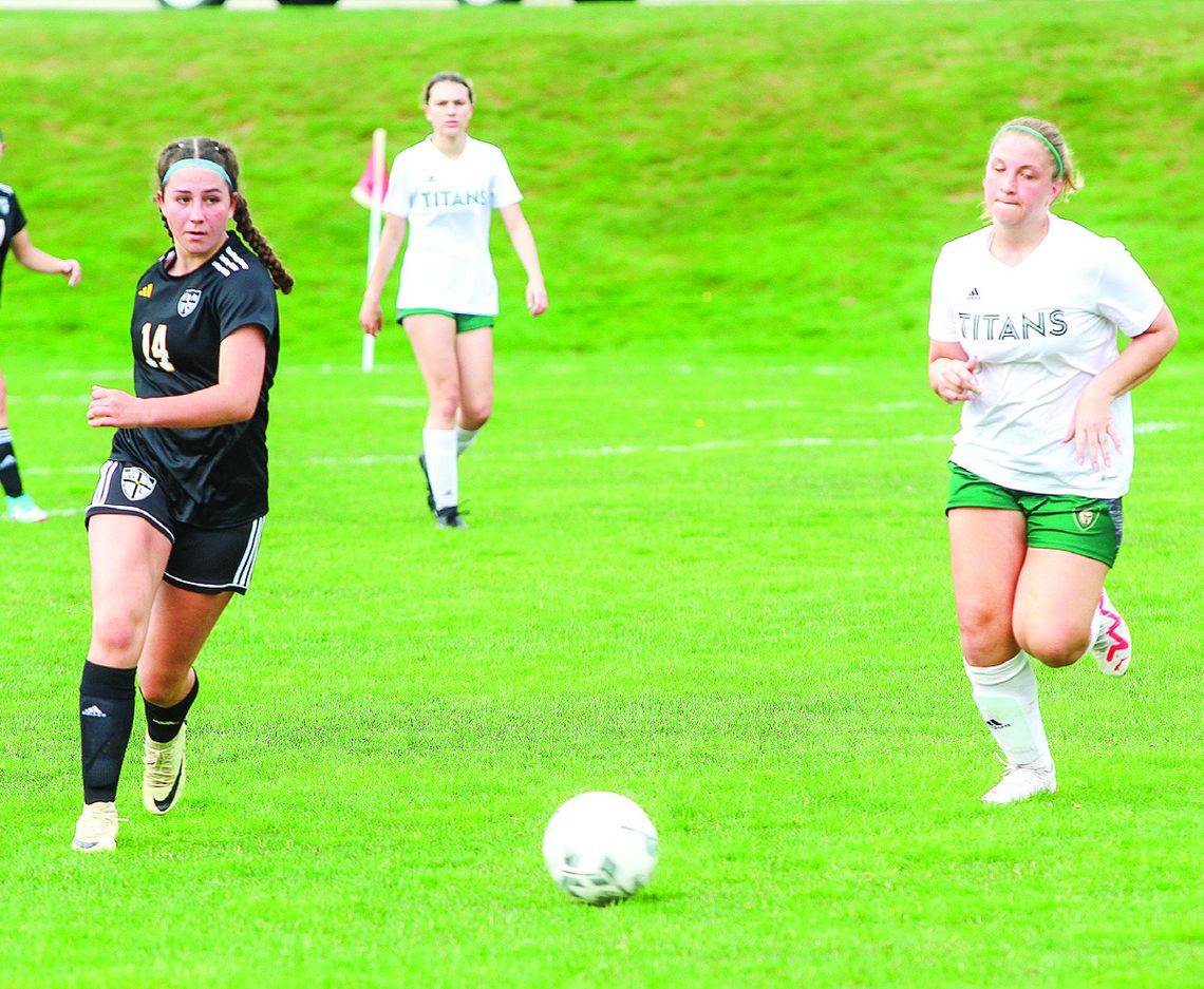 Glen Lake attacker Abbi Steffke (left) attempts a shot against TC West JV on Monday.