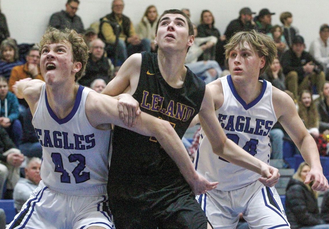 Lake Leelanau St. Mary sophomore Cody Couturier and senior Luke Gallagher box out a Leland player last week.