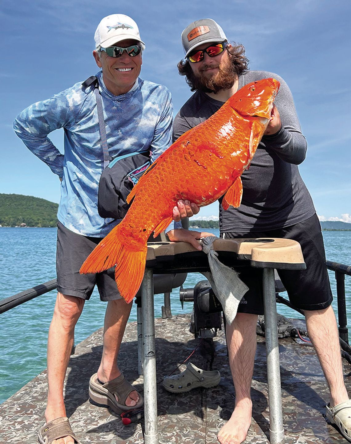 Glen Lake Association biologist Rob Karner poses with Sam James of Thundering Aspens Bow Fishing team on Little Glen Lake Monday. The spear fishing team of Greg Wright and James caught four carp, two Koi, and two common carp. One of the Koi’s was a spear fishing world record at 32.5 inches...