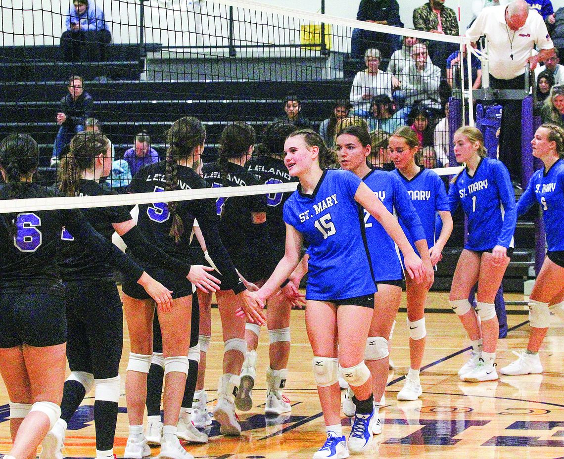 Lake Leelanau St. Mary and Leland show sportsmanship after a hard fought volleyball game Tuesday. Enterprise photo by Brian Freiberger