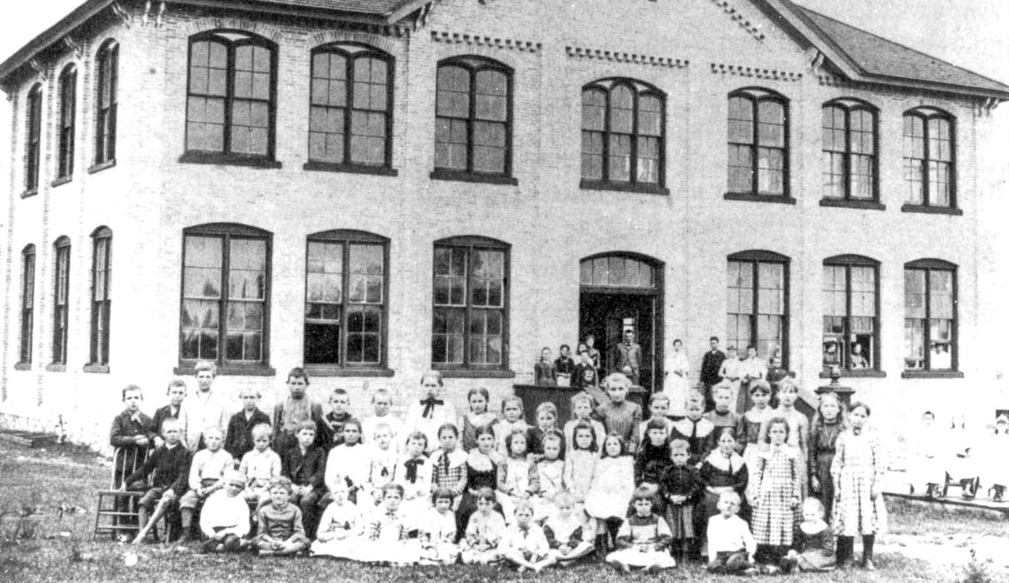 Early S-B students taught in a log cabin