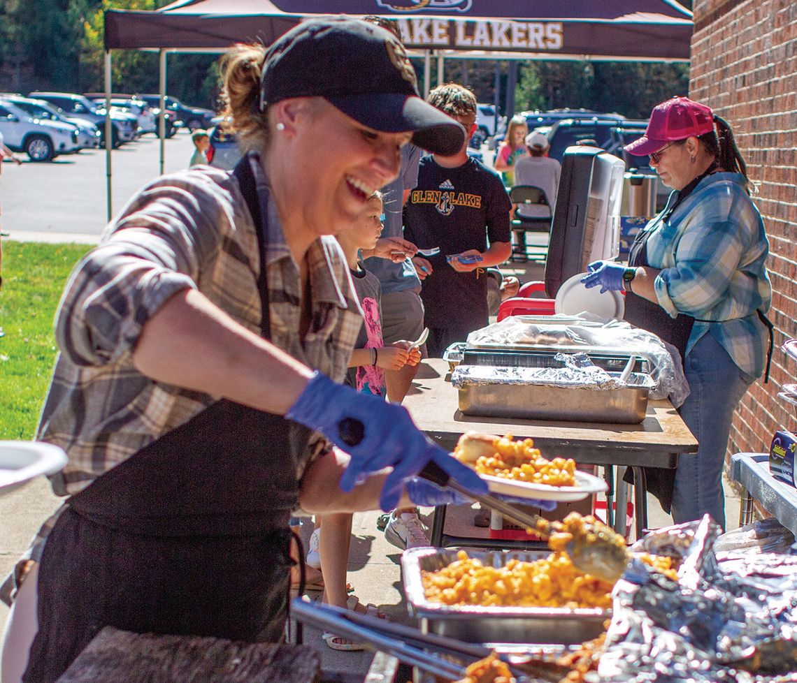 Volunteers Heidi Lindeman (foreground) and Liz Tondreau (background) served food at the pig roast.