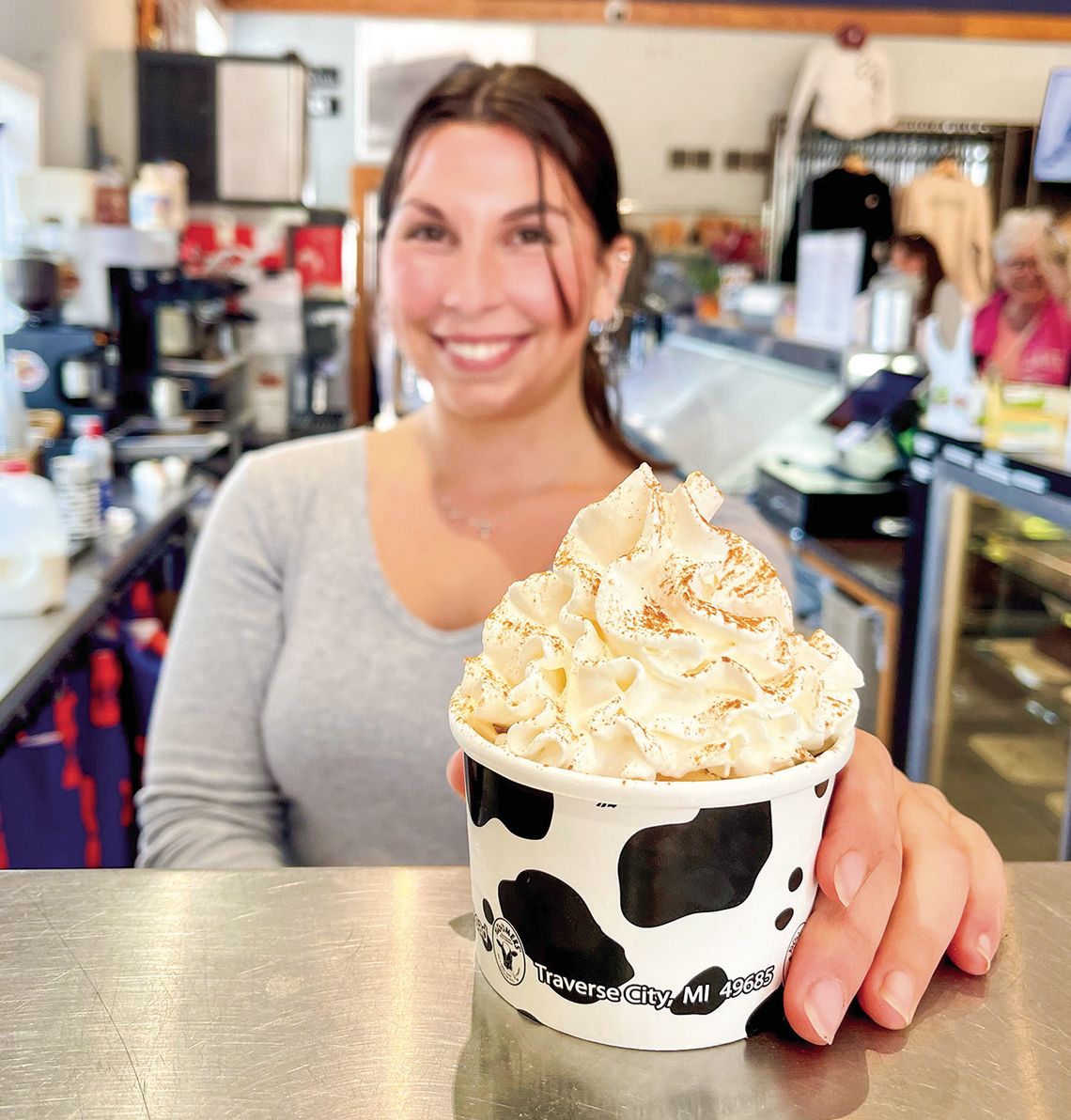 Leland Harbor House Store Manager Sophia Graham is pictured serving one of their fall favorites, a pumpkin Spice Latte (PSL) sundae. It’s made with pumpkin ice cream, a shot of espresso, whip, and cinnamon on top. Enterprise photo by Meakalia Previch-Liu