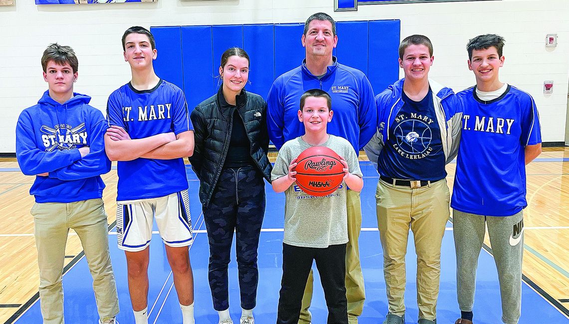 The Bunek family has kids at most ages at Lake Leelanau St. Mary. Form left to right: Rex, Josh, Della, Jim (back), Julius (front), Avery Jr., and James Bunek. Enterprise photo by Brian Freiberger