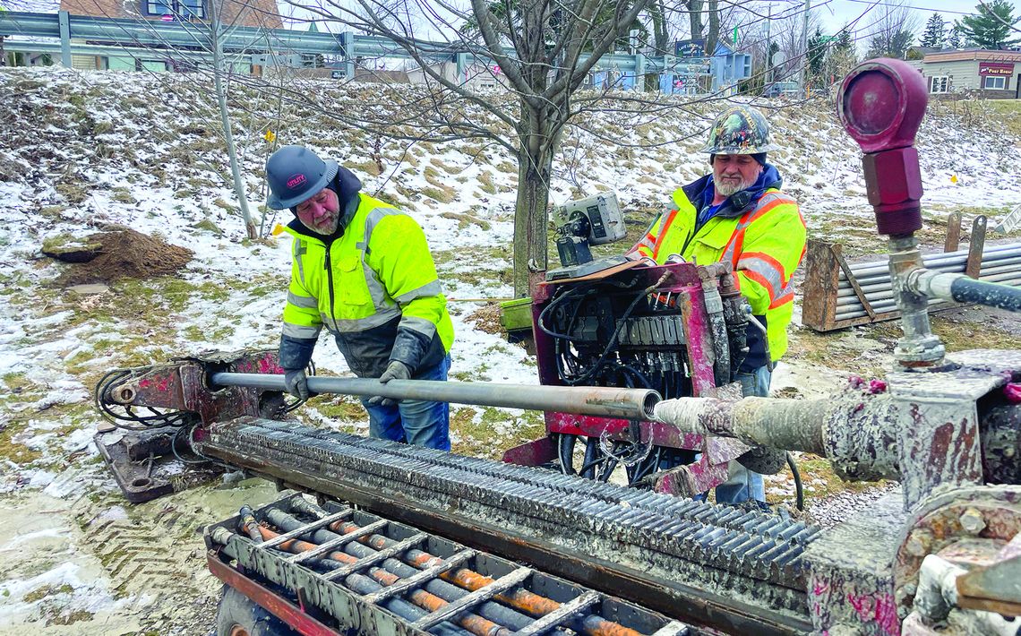 Mike Young and Joe Hess uses a trenching machine, which creates a narrow and deep channel for fiber optic cables to be installed under the Lake Leelanau Narrows. Enterprise photo by Brian Freiberger