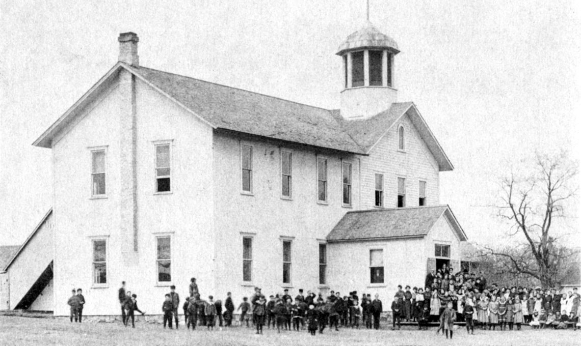The first section of the frame school house was raised in 1865. Additions were added int 1867 and 1877. Photo from “A History of Leelanau Township.”