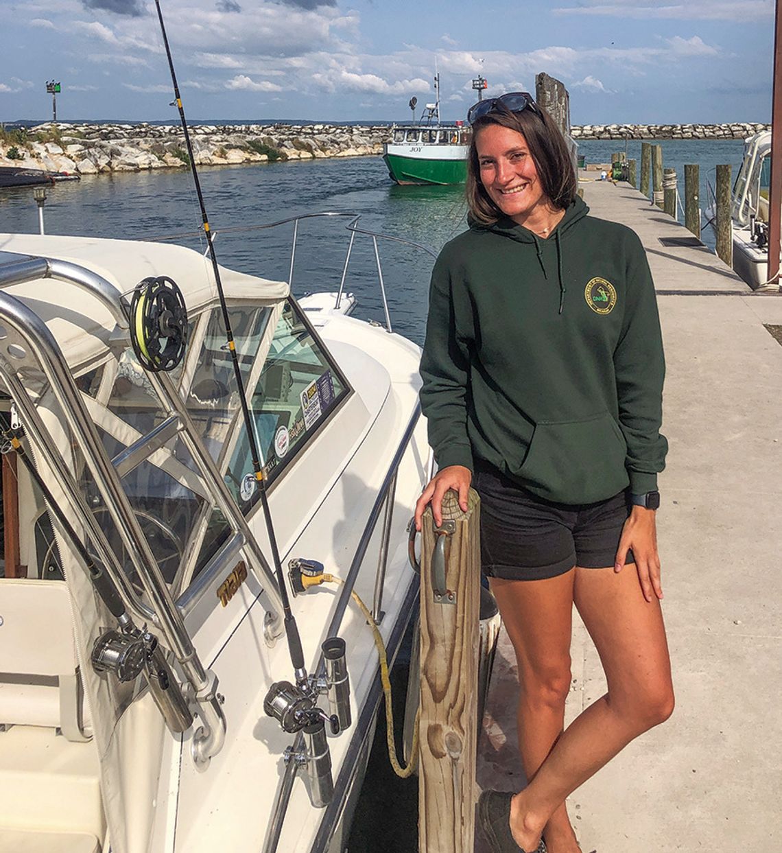 Brianna Abercrombie, who gathers information about salmon and lake trout catches off the shoreline of Leelanau County, must be in the right occupation. She enjoys fishing so much that she goes out after work despite having examined dead fish all day. Enterprise photo by Alan Campbell