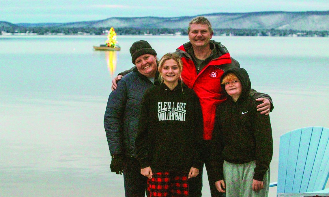 The Siepker family poses for a photo at their Glen Lake home where they bring holiday cheer to the area by setting up a christmas tree on a small rowboat that lights up the Leelanau sky. From left to right: Traci, Ashley, Frank Jr., and Frank III. Enterprise photo by Brian Freiberger