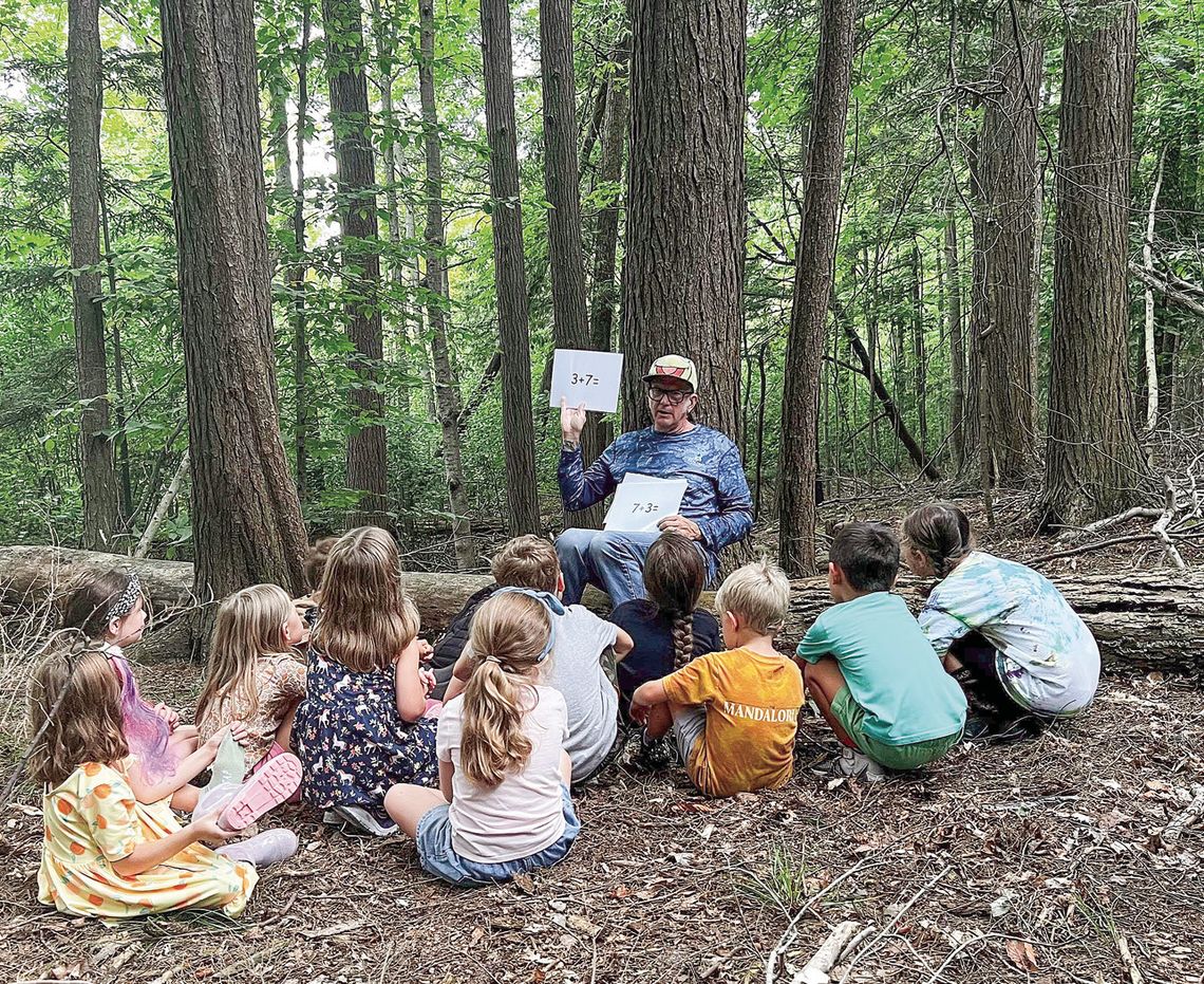 Kids participating in the Pathfinder School’s forest kindergarten program are pictured last year. Since being introduced, the program has helped not only foster a love and curiosity for the outdoors among kindergarten students, but it has also led to academic achievements. Courtesy photo