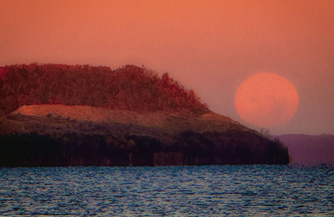 From the Good Harbor Beach access at Co. Rd. 651, the moon could be seen at its peak fullness just before setting. Photo courtesy of James Weston Schaberg