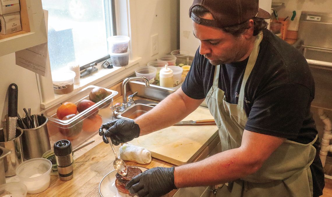 Iconic chef Justin Tootla prepares a ‘Leelanau burger’ at Gilchrist Farm in Suttons Bay. Enterprise photo by Brian Freiberger
