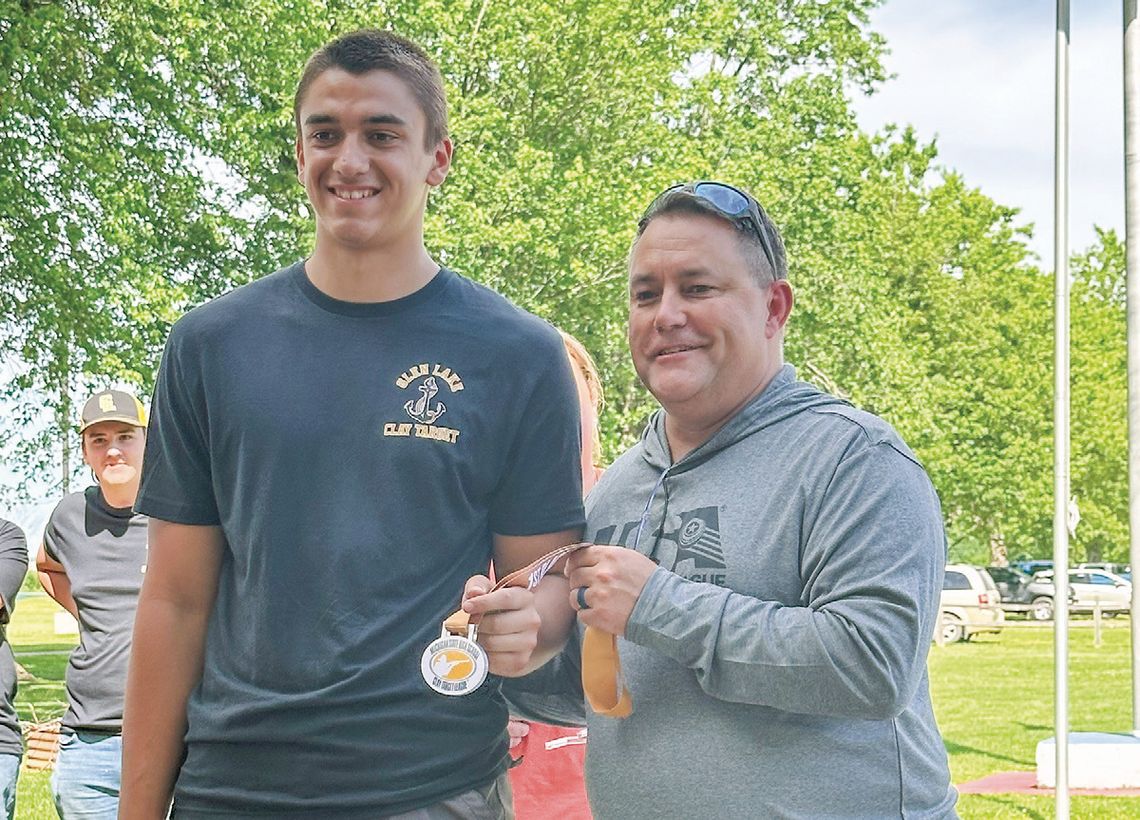Glen Lake senior Alex Eaton accepts a medal for his exceptional performance at the state competition on Saturday. Eaton along with his teammates Henry Plamondon and Ethan Verschaeve shot 25 straight. Courtesy photo
