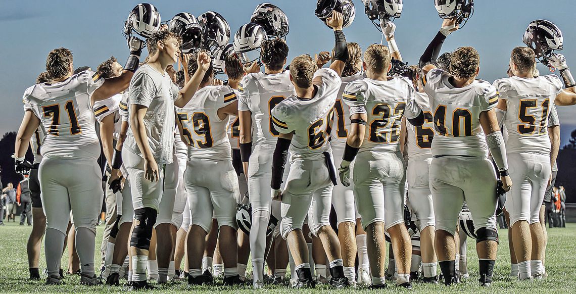 Lake raises their helmet before competing in the first game of the season against Manton.