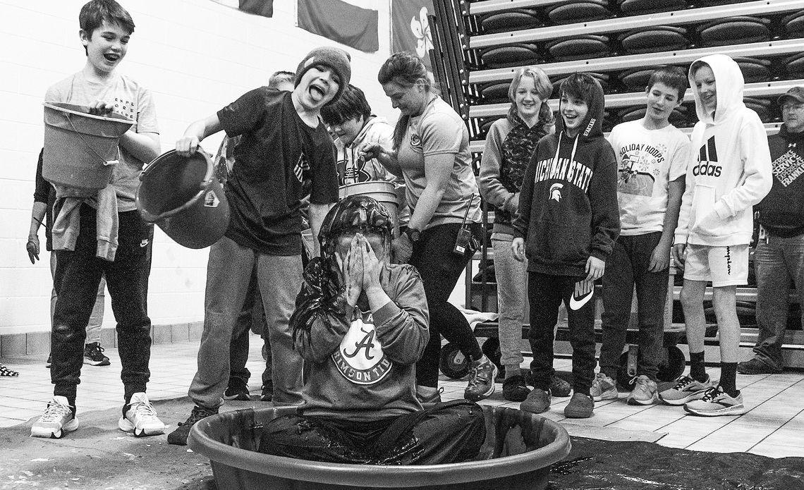 Nobody had it better than Glen Lake students on Monday as they got to slime middle school principal Dina Rocheleau after she bet against Michigan to lose in the College Football Playoff. “I’m a diehard Alabama fan and my kids are always making fun of that,” she said. “So we did a predictio...