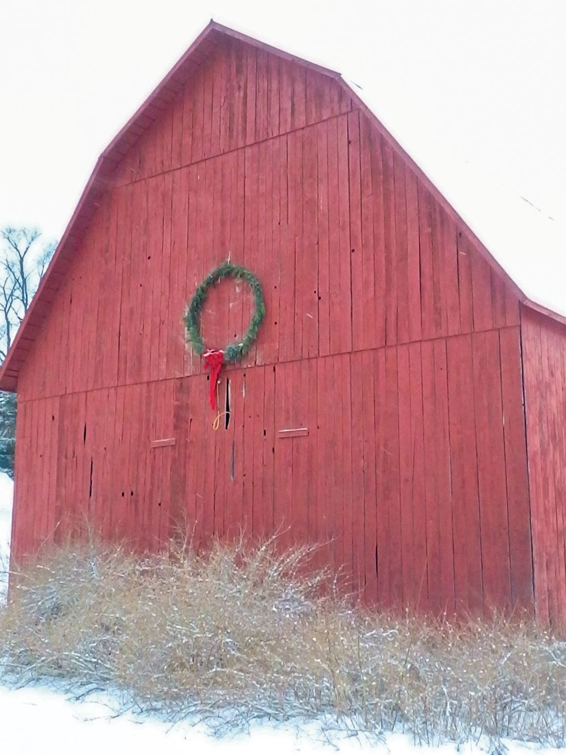 The Bolton barn just north of Empire on M-22 is decoarated each year with a large, but simple, Christmas wreath. Enterprise photo by Amy Hubbell