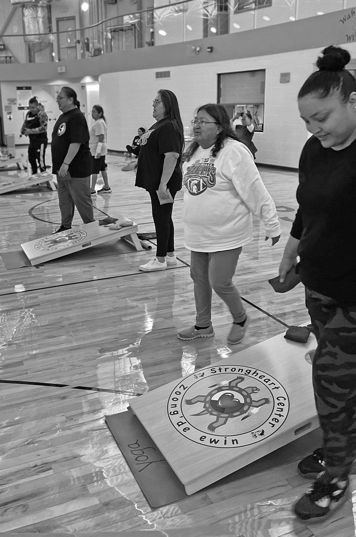 People are pictured playing against others teams in the first annual cornhole league this November at the Strongheart Center in Peshawbestown. Courtesy photo