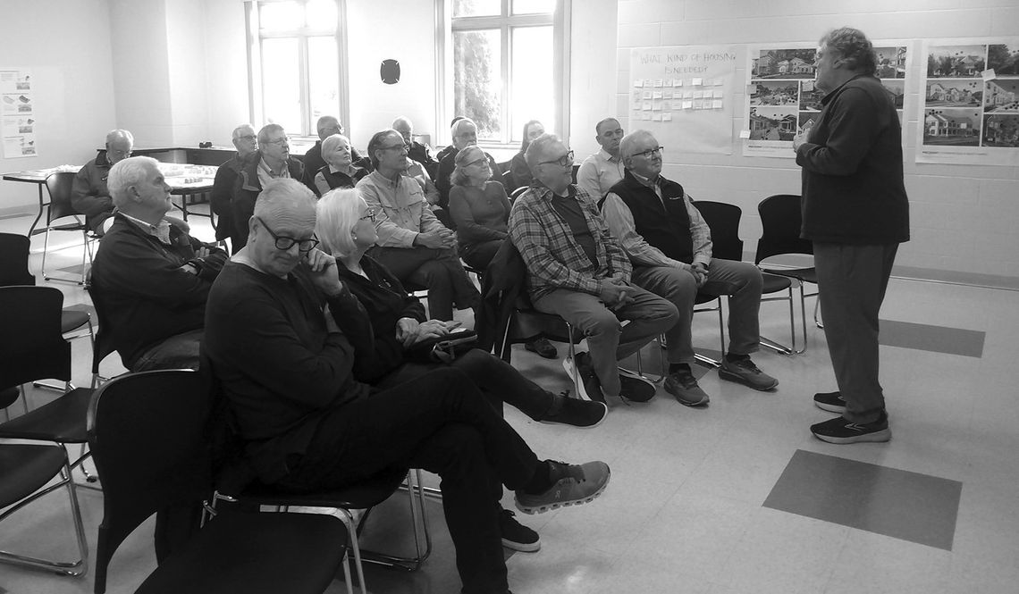 Suttons Bay residents watch and listen to a presentation by Peninsula Housing President Larry Mawby at the Suttons Bay-Bingham Fire Department May 2. This “housing workshop” served as an opportunity to exchange ideas on the area’s housing needs. Enterprise photo by Zachary Marano.