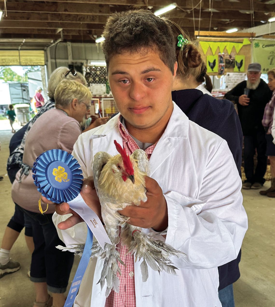 J.C. Oosse J.C. Oosse, a Lake Leelanau youth in the Michigan State University Leelanau County Extension’s 4-H Program, poses with one of his two animal projects, a bantam cock that placed first in its class at the Northwestern Michigan Fair Monday. Courtesy photo by Linda Oosse