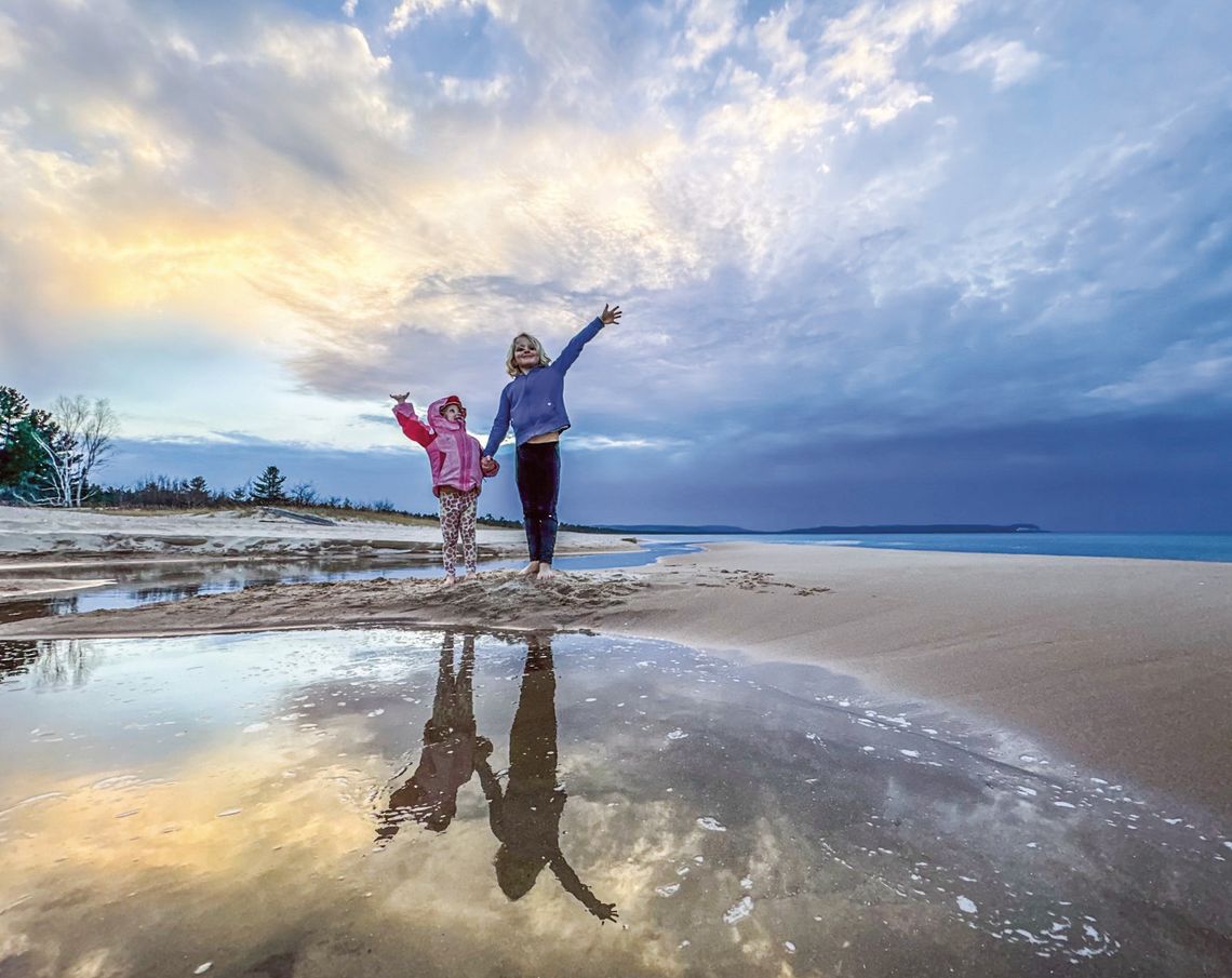 Juniper and Zinnia Schaberg Juniper and Zinnia Schaberg, ages 8 and 3 respectively, greeted an early spring with bare feet last week at the mouth of the stream that feeds Good Harbor. Photo courtesy of James Schaberg