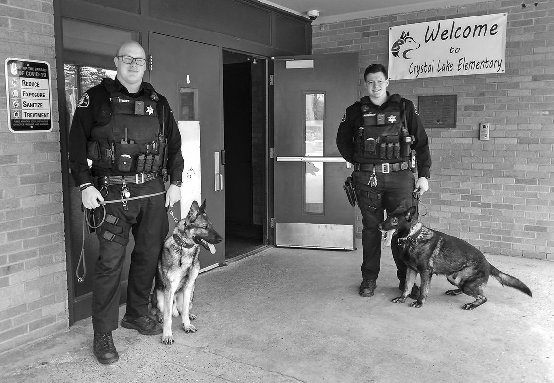 Deputies Jordan Strope and Cameron Drzewiecki and their respective K-9 companions, Keno and Klouse, trained last week at an empty school in Benzonia. Enterprise photo by Zachary Marano