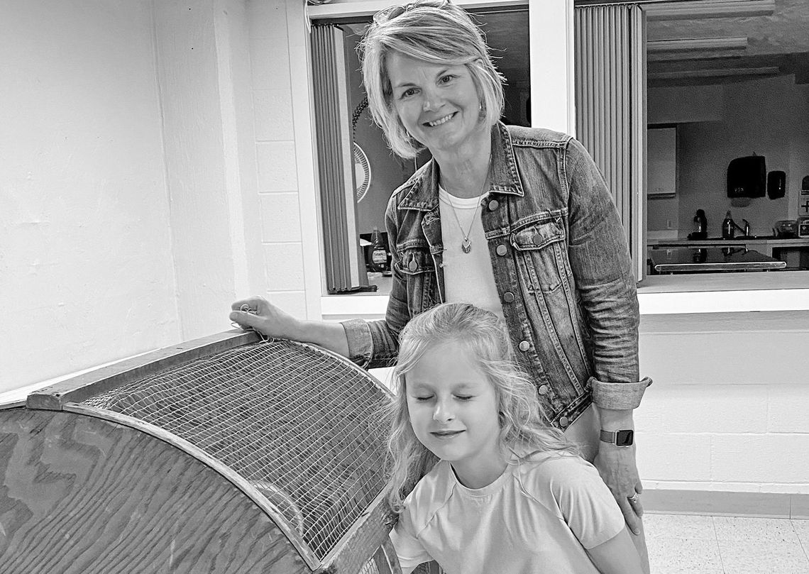 Lori Schaub pulls a winning ticket out of the bin with a young helper. Courtesy photo