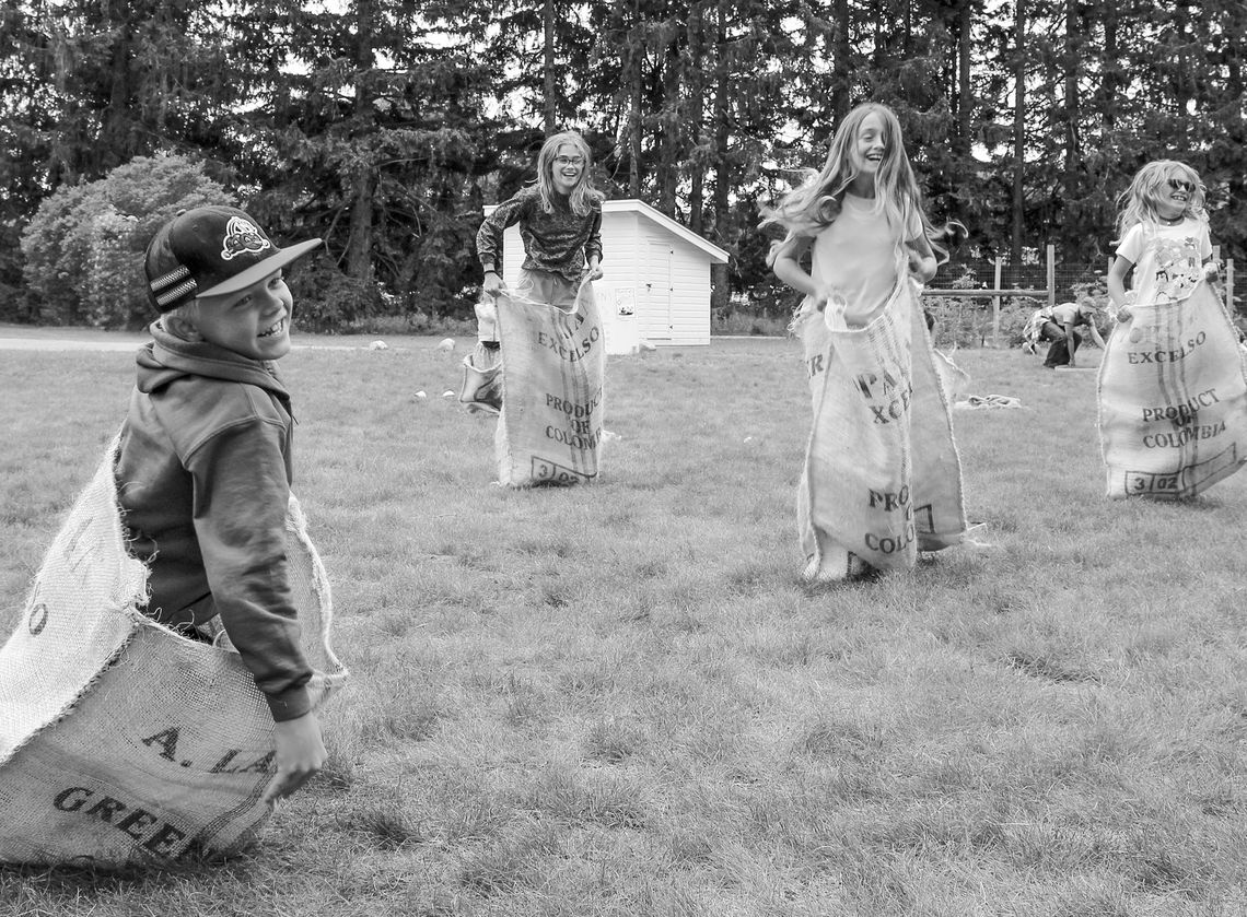 Kids enjoy Kids enjoy a “good old fashioned” burlap sack race at the Olsen farm. Family games are just one of the many interactive and hands-on activities at the Port Oneida Fair, Aug. 10 and 11. Photo courtesy of the National Park Service.