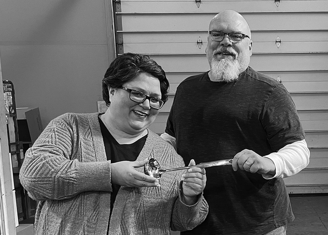 Patrice Korson smiles as last year's Souper-Bowl winner Mike Anderson, creative director, presents her with the coveted Silver Ladle Award. We will post Patrice's recipe in the online version of this story at leelanaunews.com. Enterprise photo by Meakalia Previch-Liu