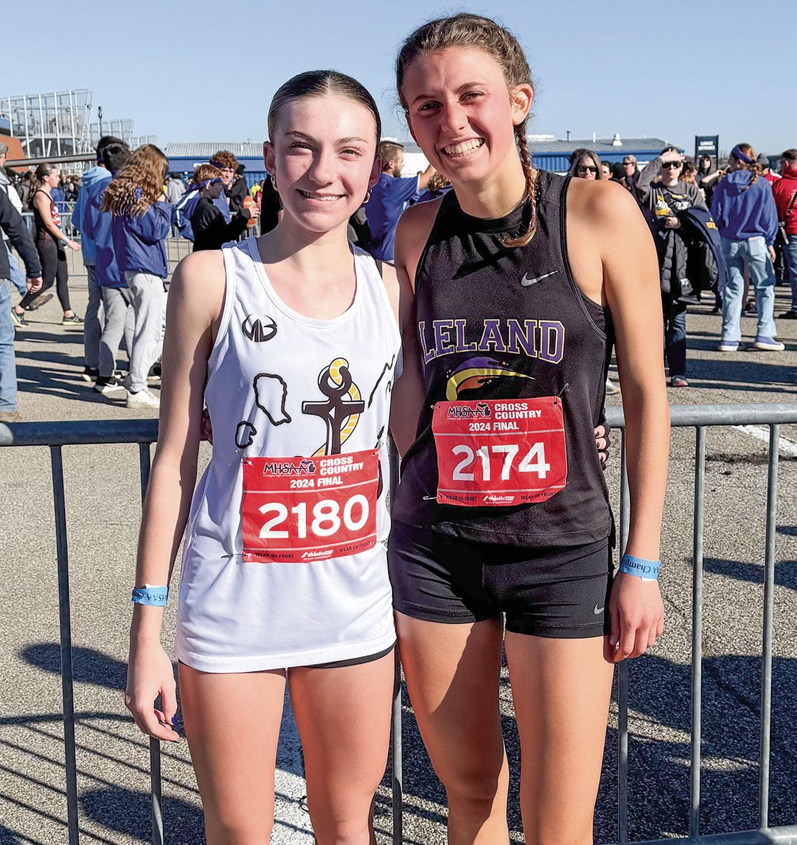 Glen Lake freshman Carmella Julian (left) and Leland senior Ella Knudsen share a moment after the state championship race at Michigan International Speedway Saturday. Courtesy photo