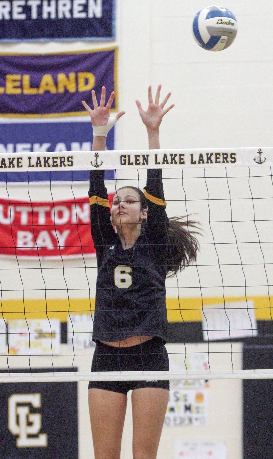 Glen Lake sophomore Avery Flores blocks a Benzie attack during a homecoming volleyball game Thursday.