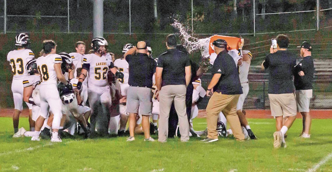 Glen Lake coach Jesse Smith received a cold shower after watching his Lakers win a close and crucial Northwest Conference football game 7-6 Friday. Photo Courtesy of Michele Aucello