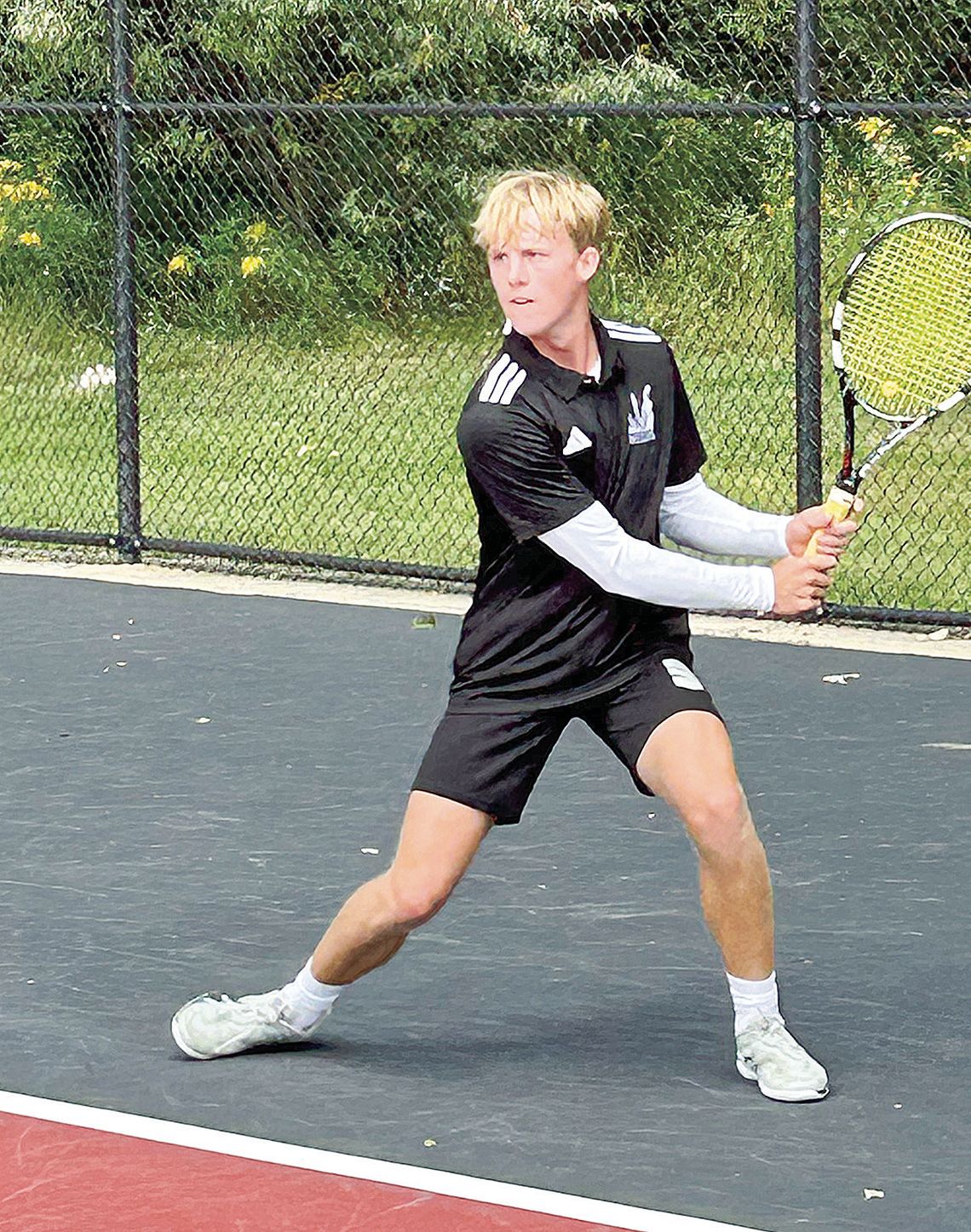 Glen Lake senior Michael Houtteman setting up for a topspin backhand against Grand Haven. Courtesy photos