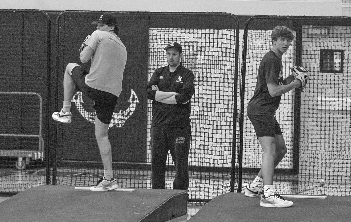Glen Lake pitchers Keaton Lacross (left) and Justin Halvka (right) warm up during practice indoors on Tuesday. Enterprise photo by Brian Freiberger