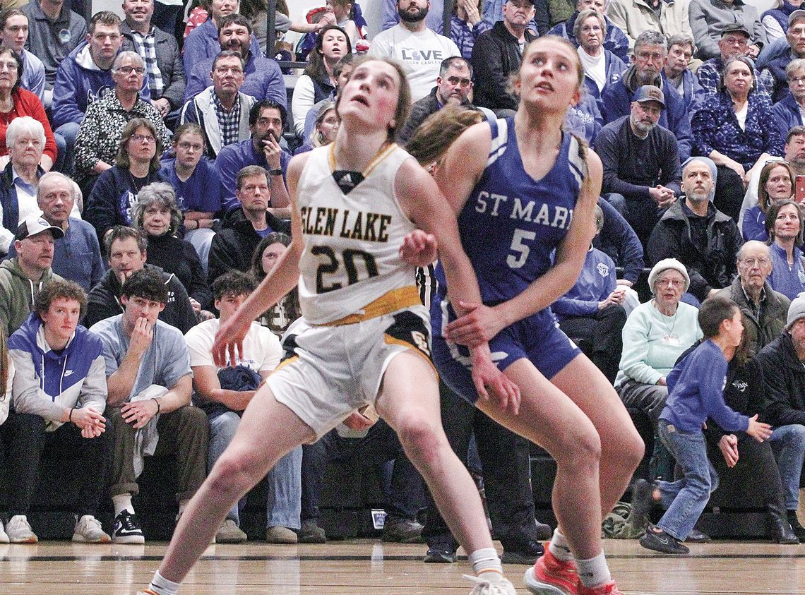 Glen Lake sophomore Lydia Fosmore and St. Mary senior Kyla Barnowski battle for a rebound during a district final game last season. Enterprise photo by Brian Freiberger