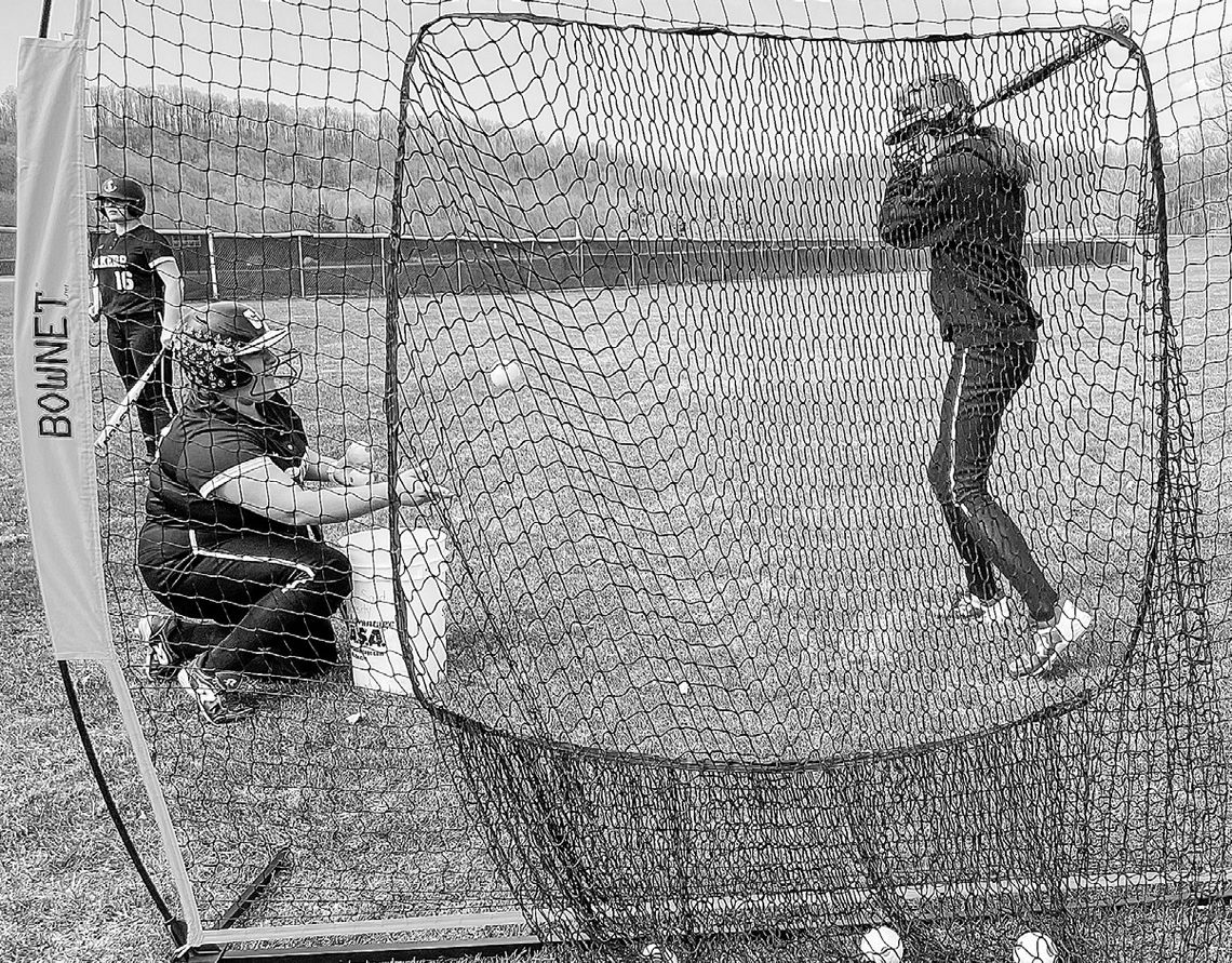 Glen Lake seniors Paige Flores (right) and Ella Flores (left) practice for the upcoming softball season. The Lakers had their first game on the road yesterday against Lake Leelanau St. Mary. Enterprise photo by Brian Freiberger