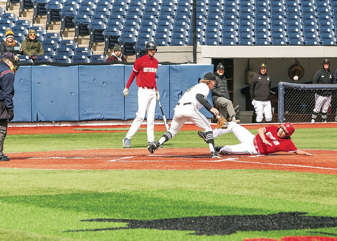 Glen Lake pitcher Peter Gelsinger runs to home plate just in time to tag a Suttons Bay runner in a close call. Photo courtesy of Nicole Marton