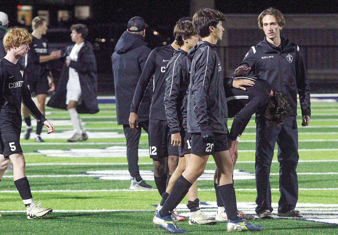 Leland players console each other after losing in the regional final Thursday against Muskegon Western Michigan Christian. Enterprise photos by Brian Freiberger