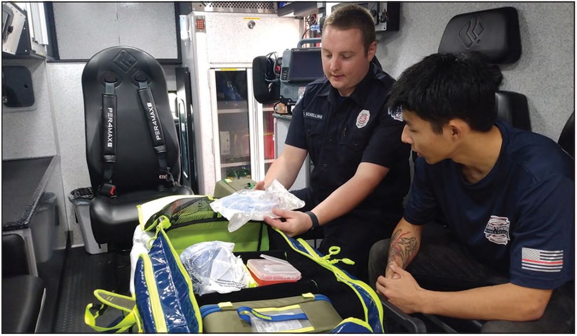 Vinni Ciricola, right, a student intern from Eastern Michigan University, learns medical response skills from Leland Township Fire &amp; Rescue Lieutenant Chris Schelling at the Lake Leelanau station. Ciricola is interning with the department over the summer to fulfill course requirements...