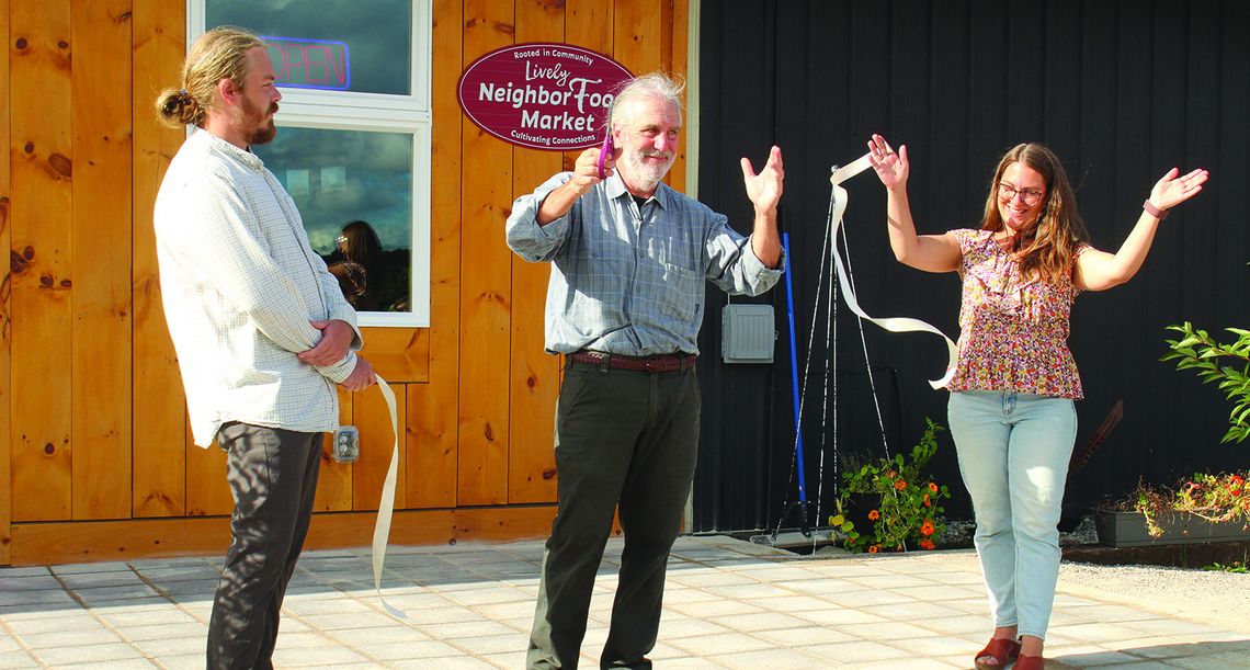 Jim Lively cuts the ribbon of the official opening of The Lively NeighborFood Marker on M-72, right before you get to Empire. Enterprise photo by Brian Freiberger