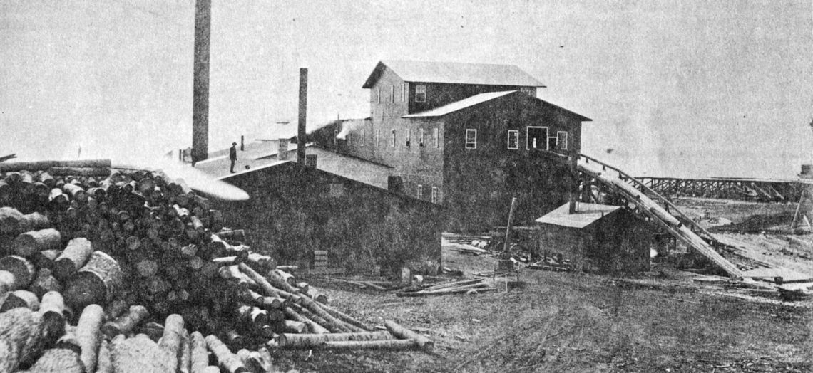 The second Empire Mill with tramway to right, power slide with endless chain for hauling logs into the mill. Photo courtesy of the Empire Area Heritage Group