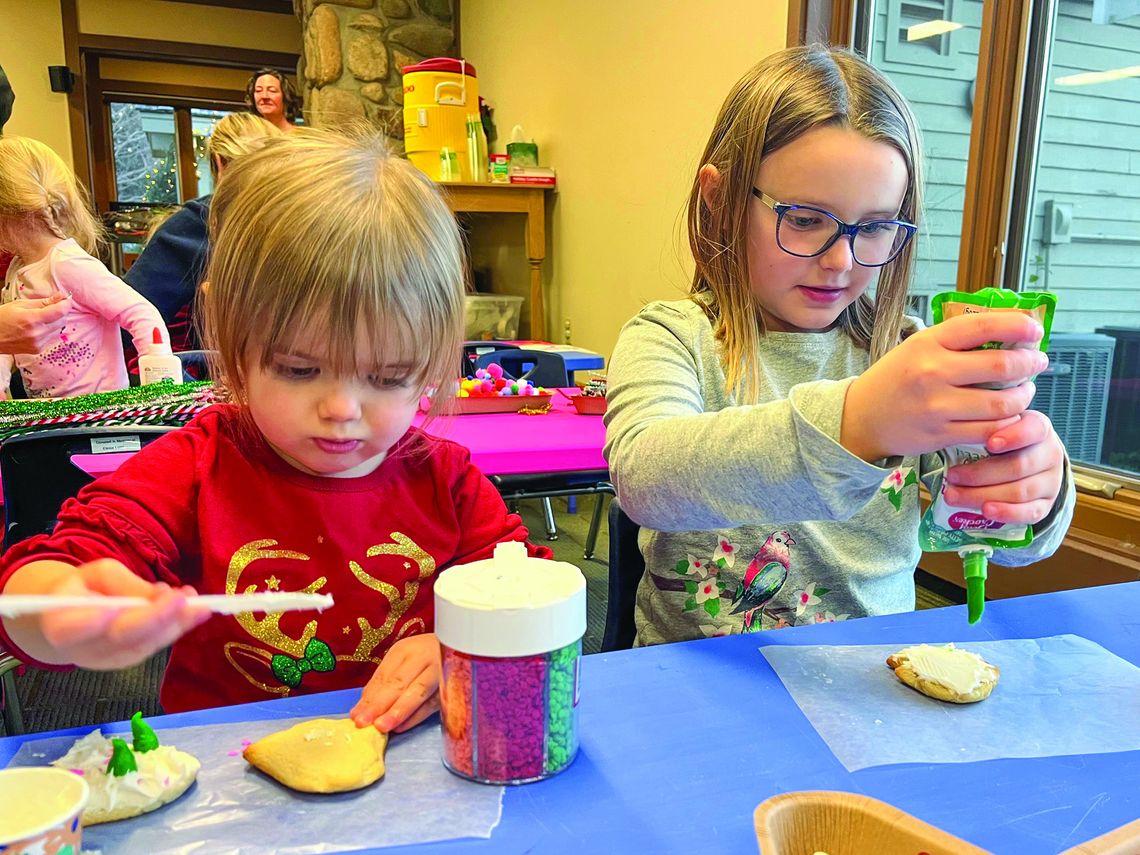 Madison and Savannah Potes Madison and Savannah Potes, from left, are shown decorating cookies at a recent Parenting Communities event. The girls are from Northport. Photo courtesy of Courtney Yaple