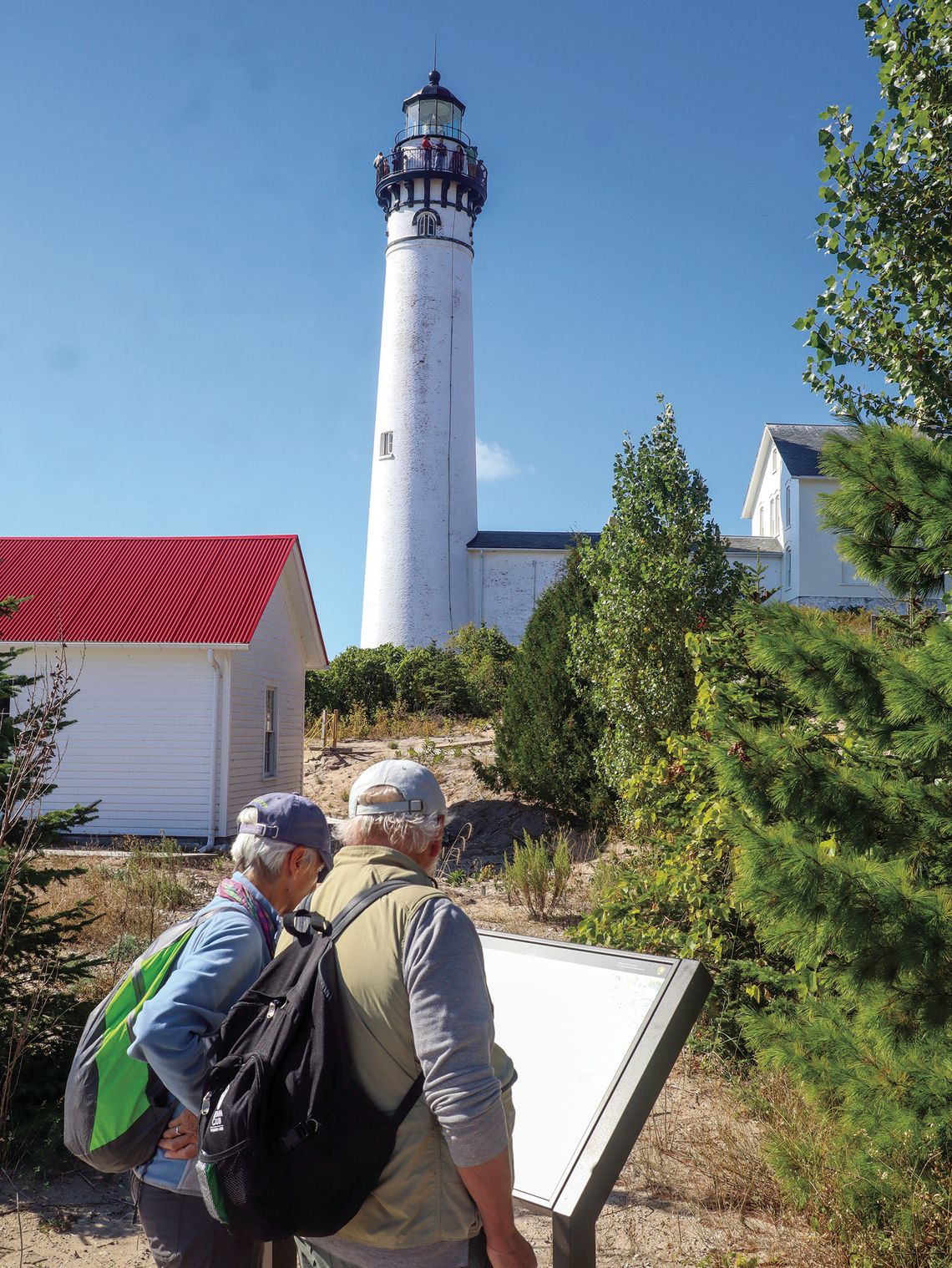 Mainland visitors took in the beauty of the South Manitou Lighthouse during a day trip hosted by the Leelanau Historical Society Monday. Enterprise photo by Brian Freiberger